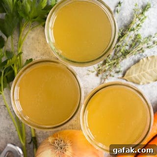 top down shot of mason jars filled with turkey stock and ingredients lying next to them