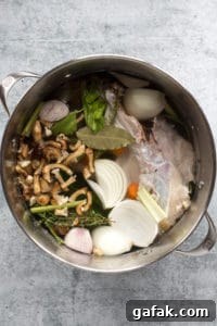 a large pot with ingredients for turkey stock in it.