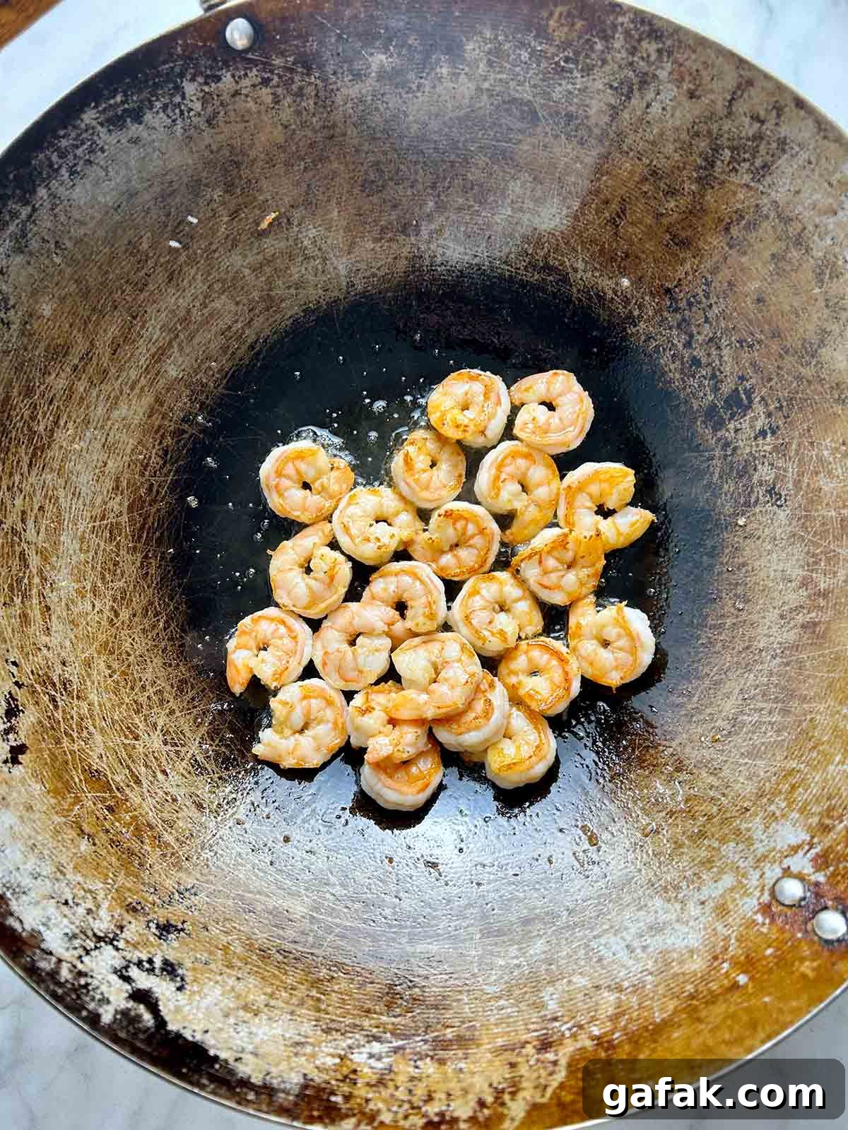 frying shrimp in wok