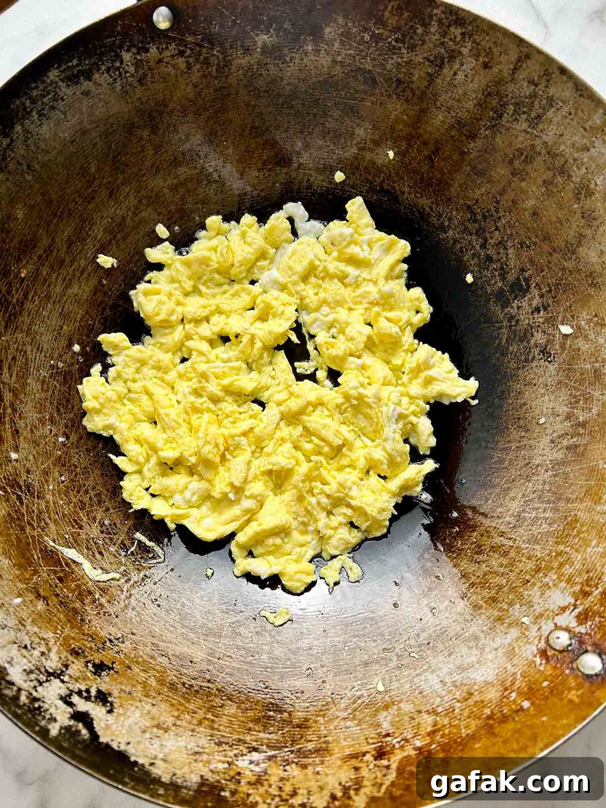 frying eggs in wok