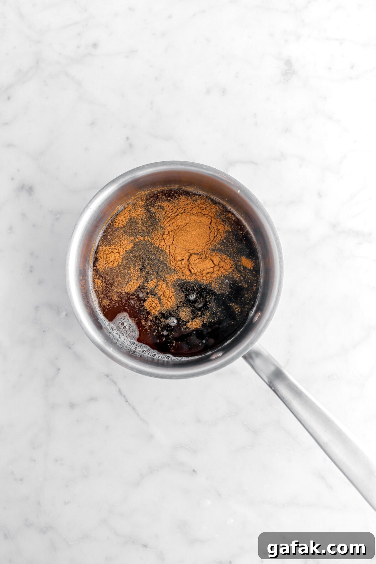 ground cinnamon, water, dark syrup, and brown sugar in small pot.