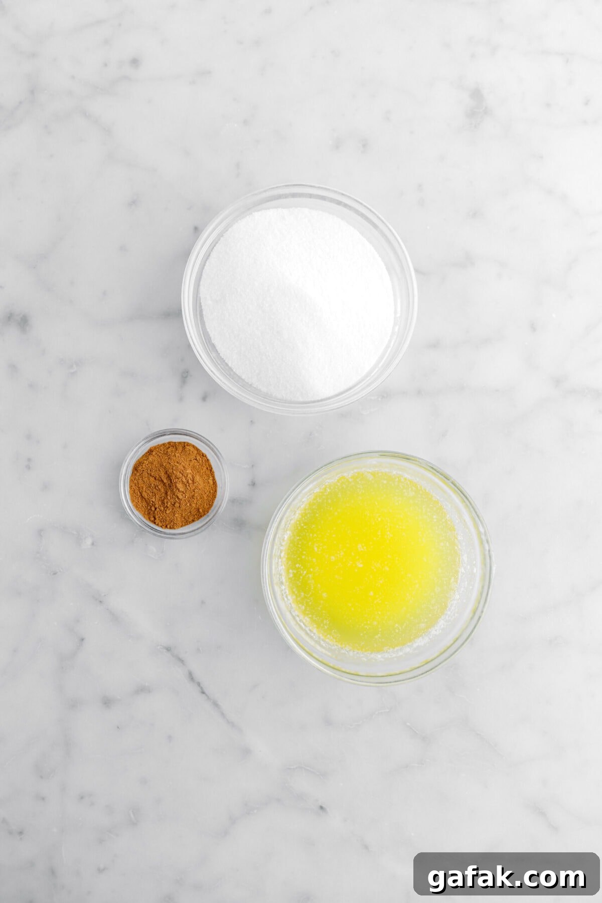 sugar, cinnamon, and melted butter on marble surface.