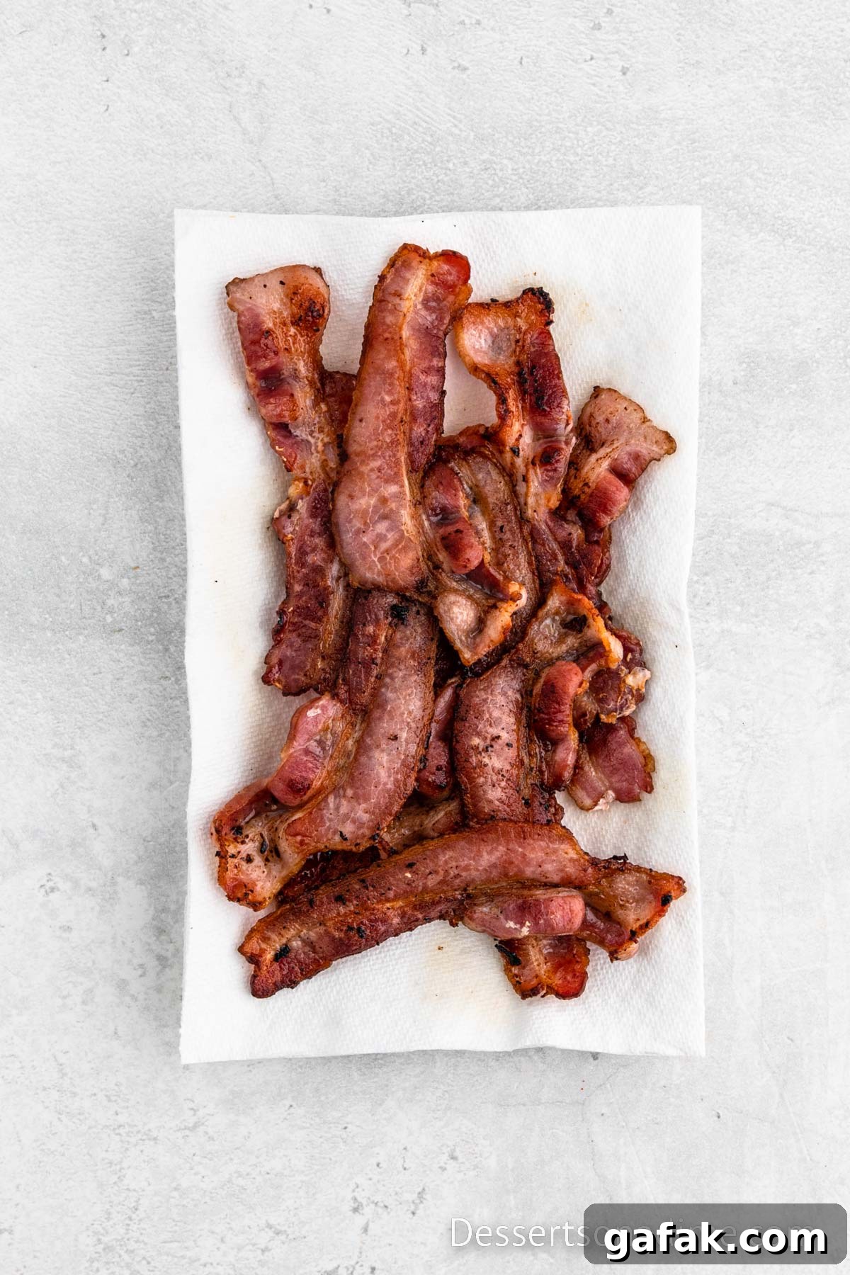 Plate of bacon with paper towel. 