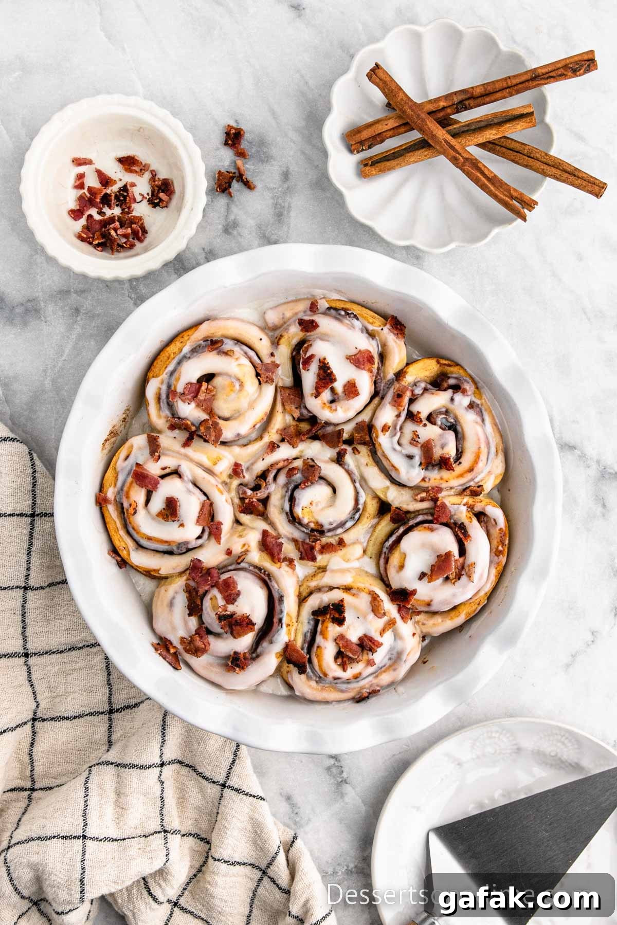 Cinnamon rolls baked and topped with extra bacon. 
