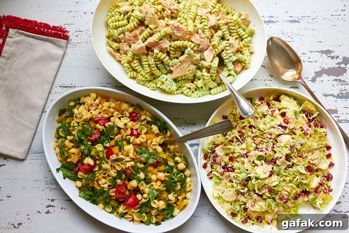 Bowl of Mayo-Free Vegan Pasta Salad on a table with other pasta salads.