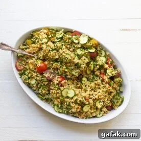 Tomato, Zucchini and Bulgur Salad in bowl with spoon.