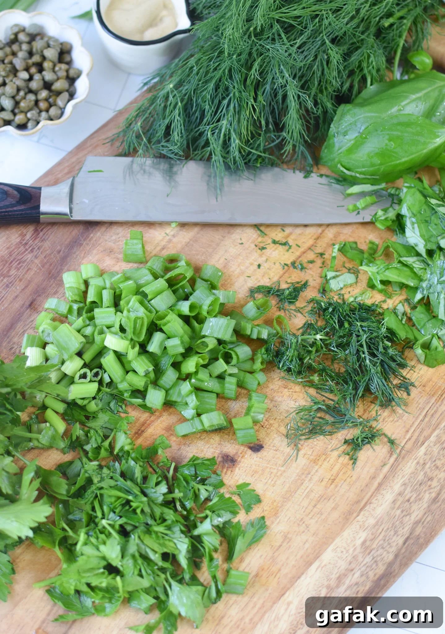No Mayo Potato Salad herbs on a cutting board.
