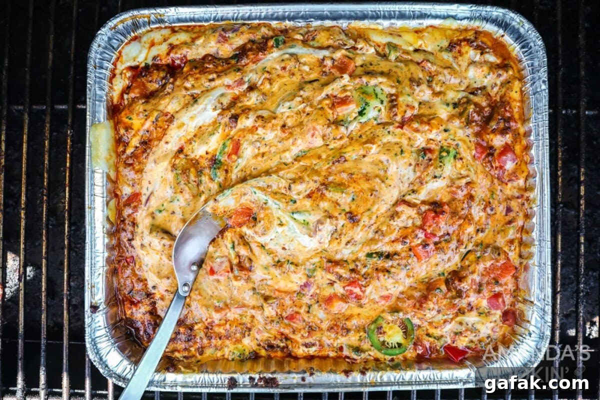 finished smoked queso dip in a pan inspired by tik tok