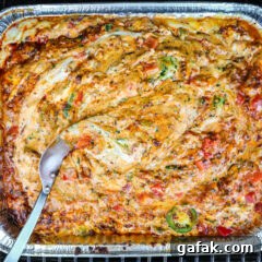smoked queso dip in a foil pan