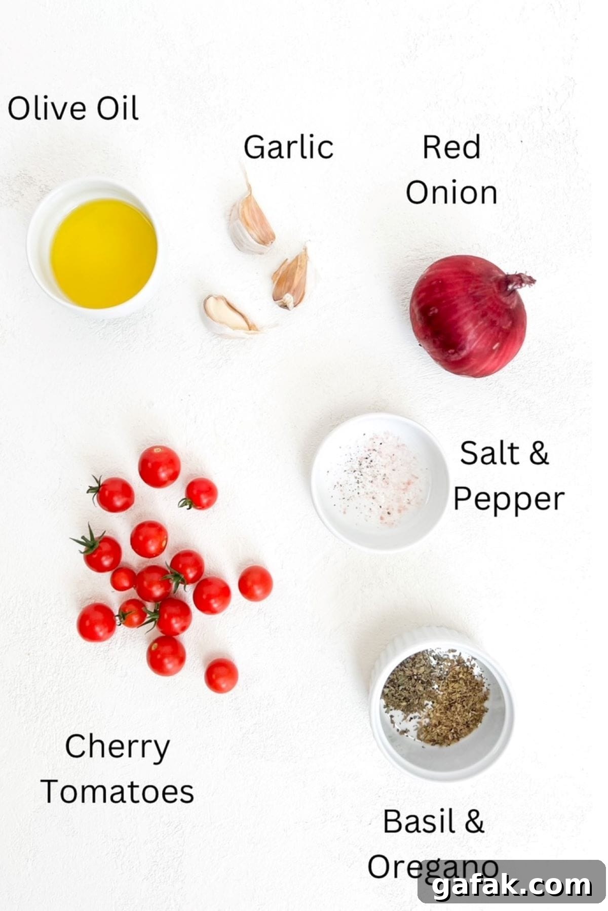 Olive oil, three garlic cloves, one red onion, cherry tomatoes, salt and pepper, basil and oregano placed separately on a white background and labeled.