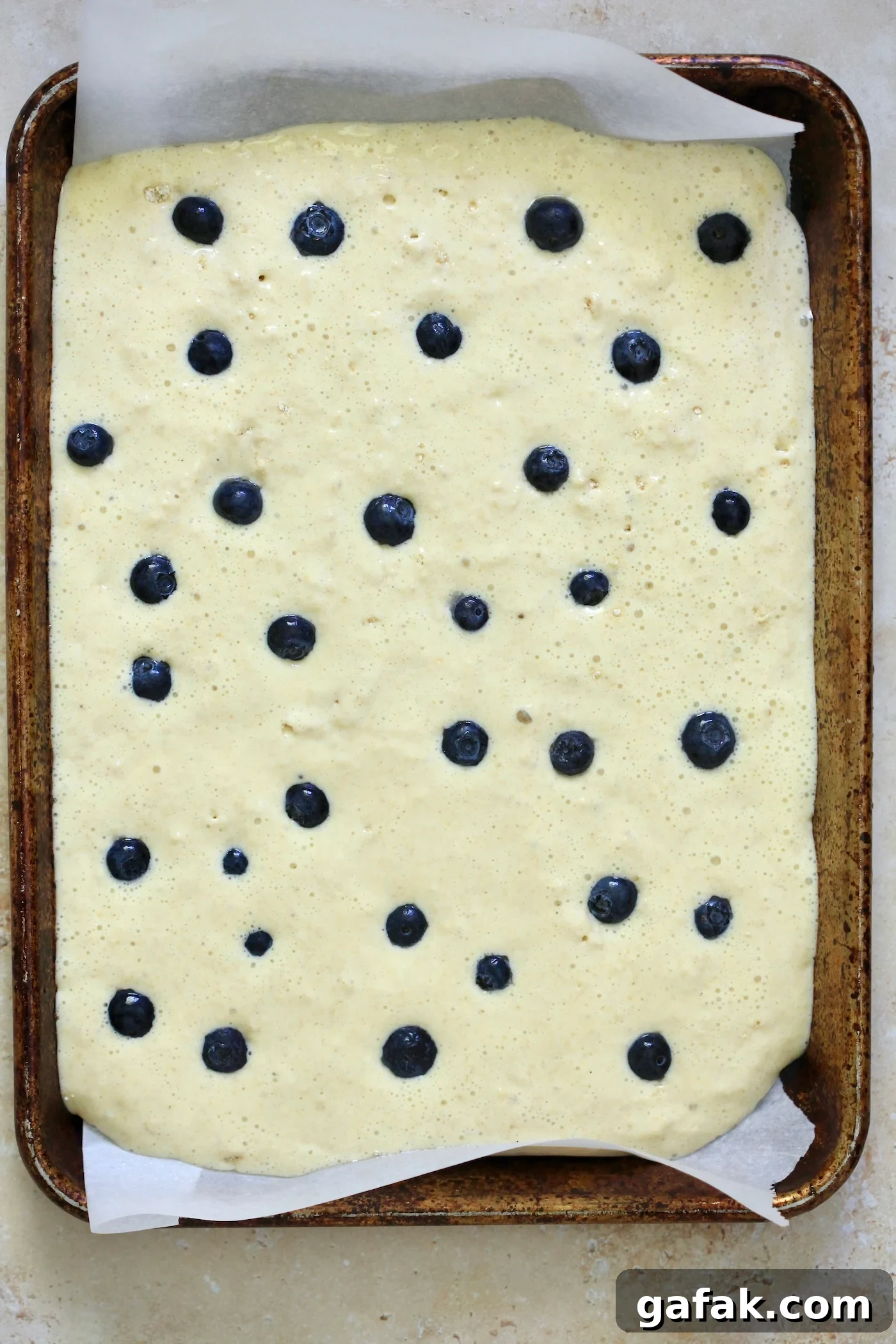 batter in sheet pan with bluberries.