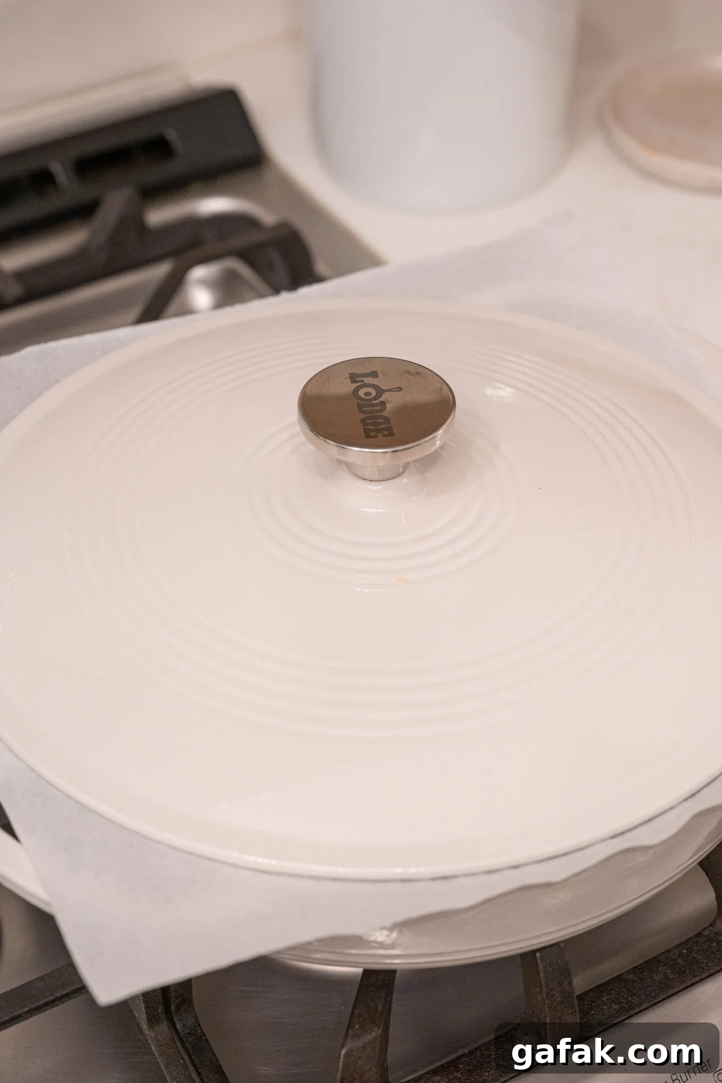 A dutch oven with parchment paper lid.