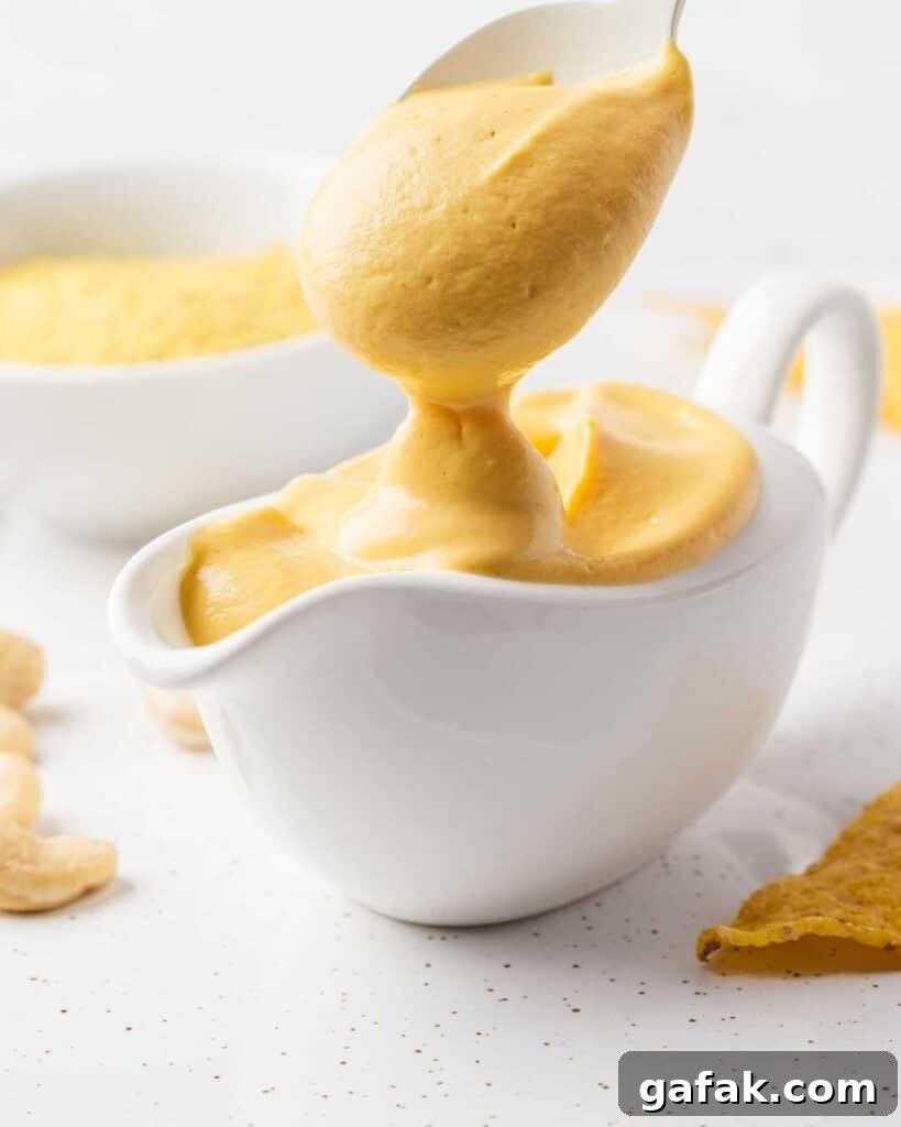 Pouring cheese sauce in a gravy bowl.