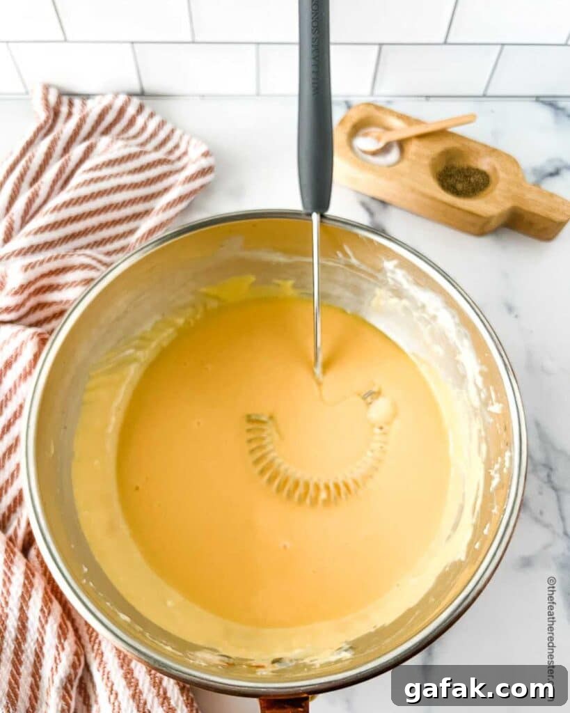 Whisking cheese in a bowl.