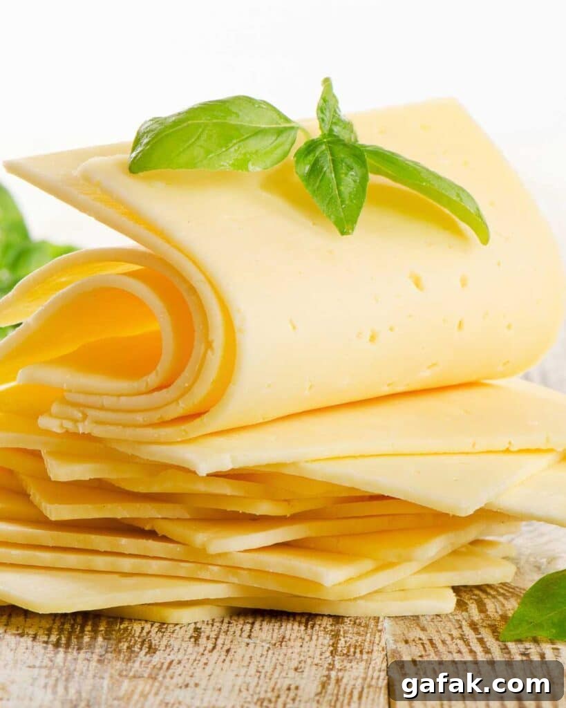American cheese artfully arranged topped with basil leaves.