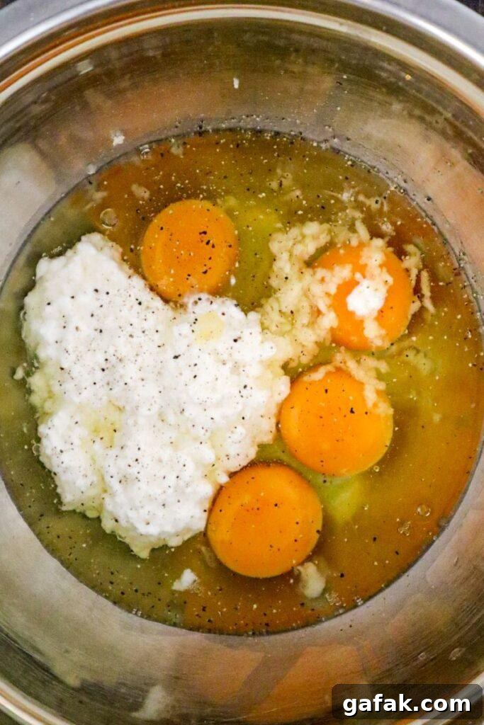 raw eggs and cottage cheese in mixing bowl