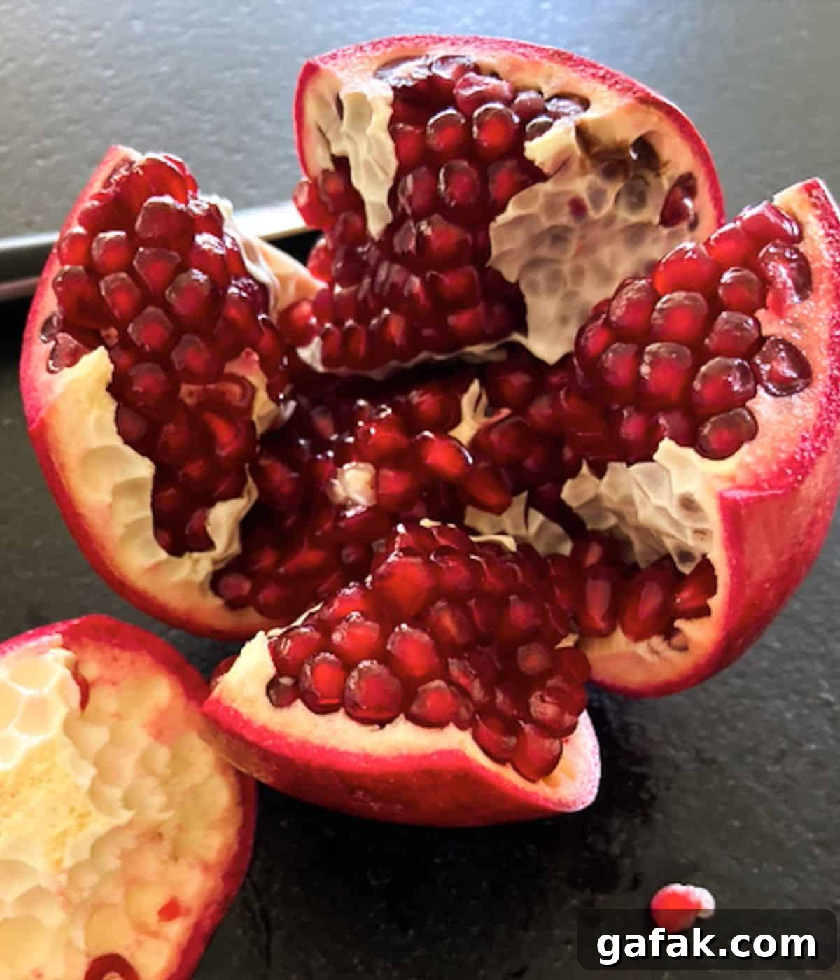 pomegranate cut and pulled open on countertop