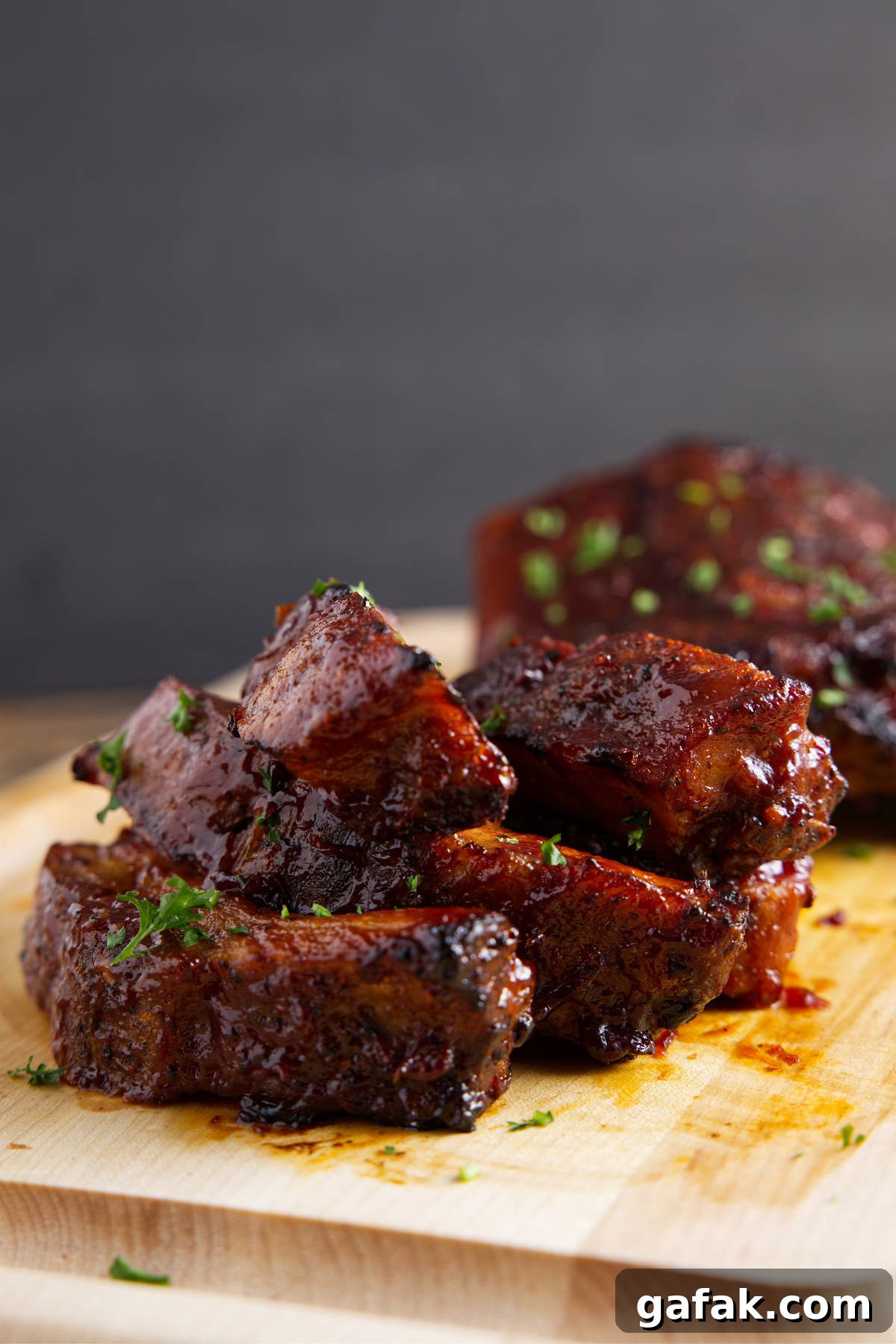 Saucy pork ribs reheated in the air fryer and resting on a cutting board.