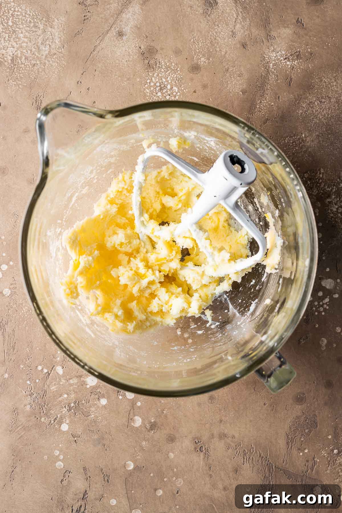 Wet ingredients for pastry dough in a clear glass mixing bowl.
