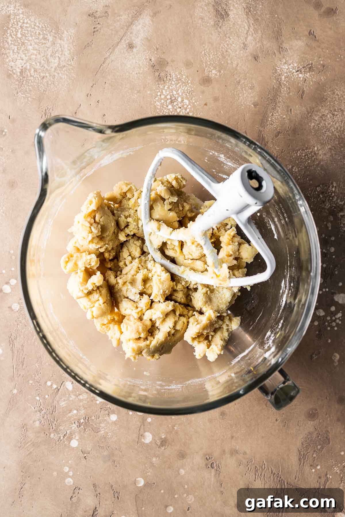 Finished tart dough in a glass mixing bowl.