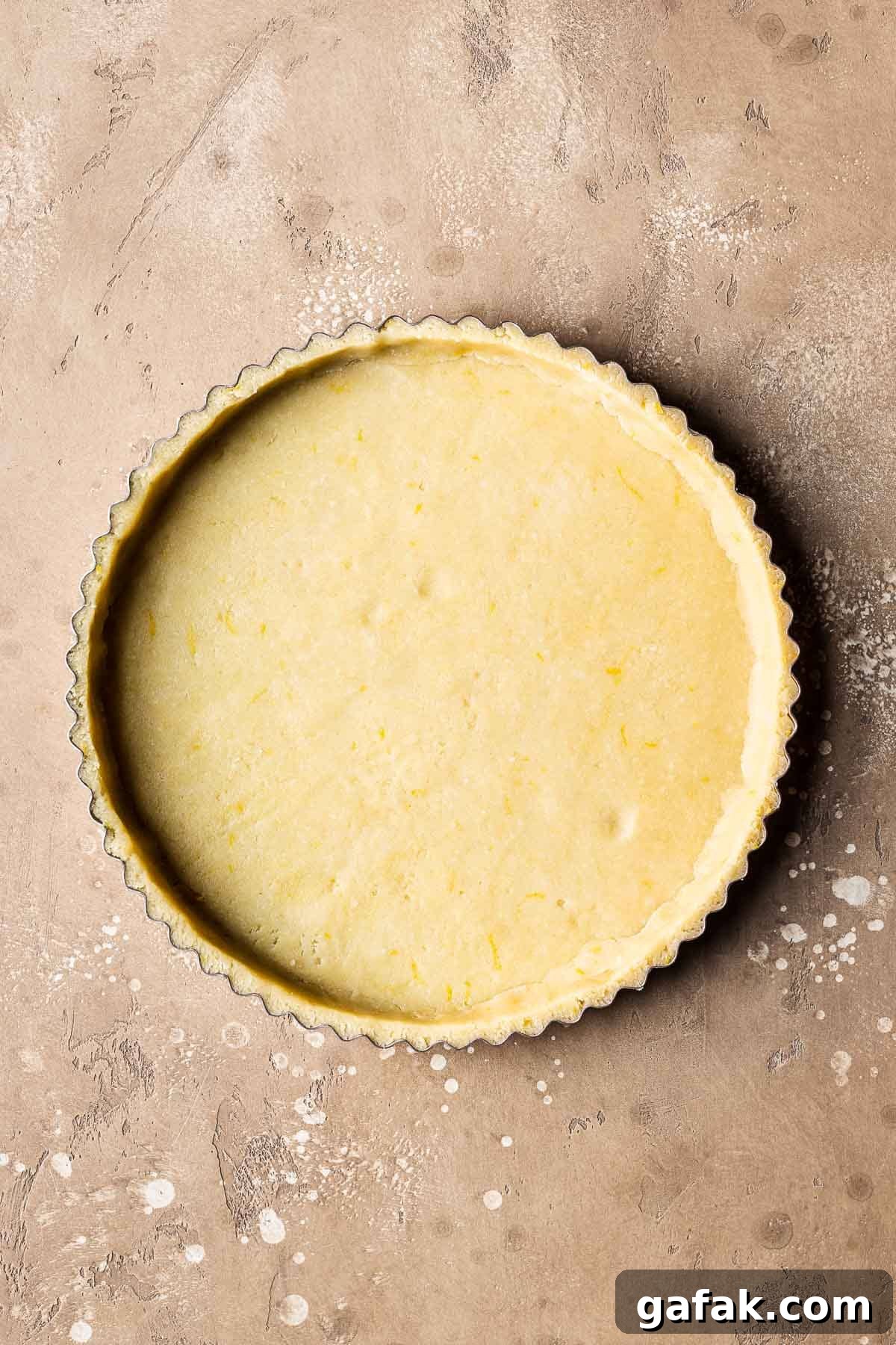 Unbaked pastry dough in a fluted tart pan.