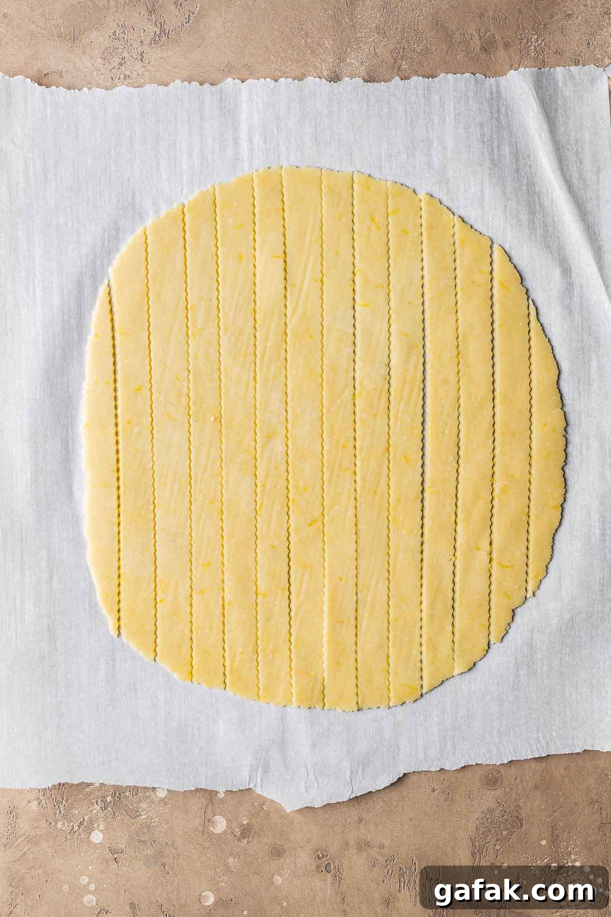 Lattice dough strips on white parchment paper.