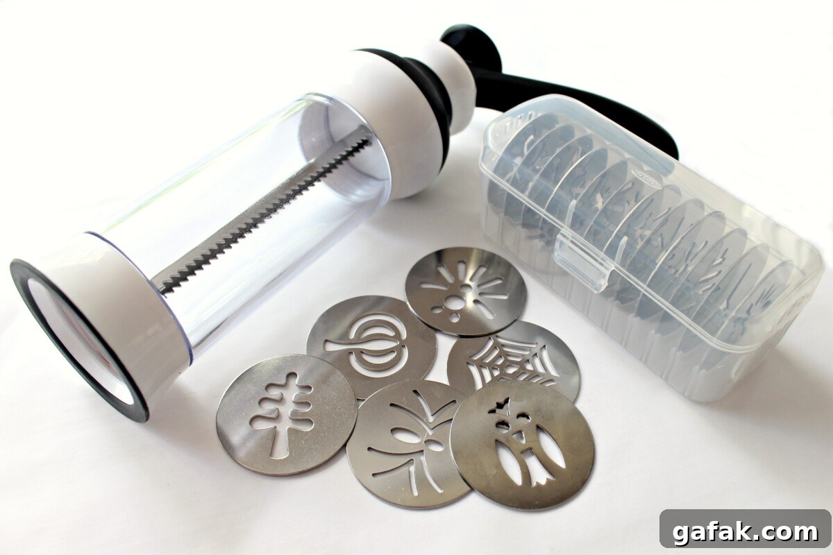 Cinnamon Spritz Owl Cookies are buttery cookies warmed with cinnamon and baked until crisp. A cookie press easily makes dozens of owls in minutes! | themondaybox.com Oxo cookie press with discs and disc case.