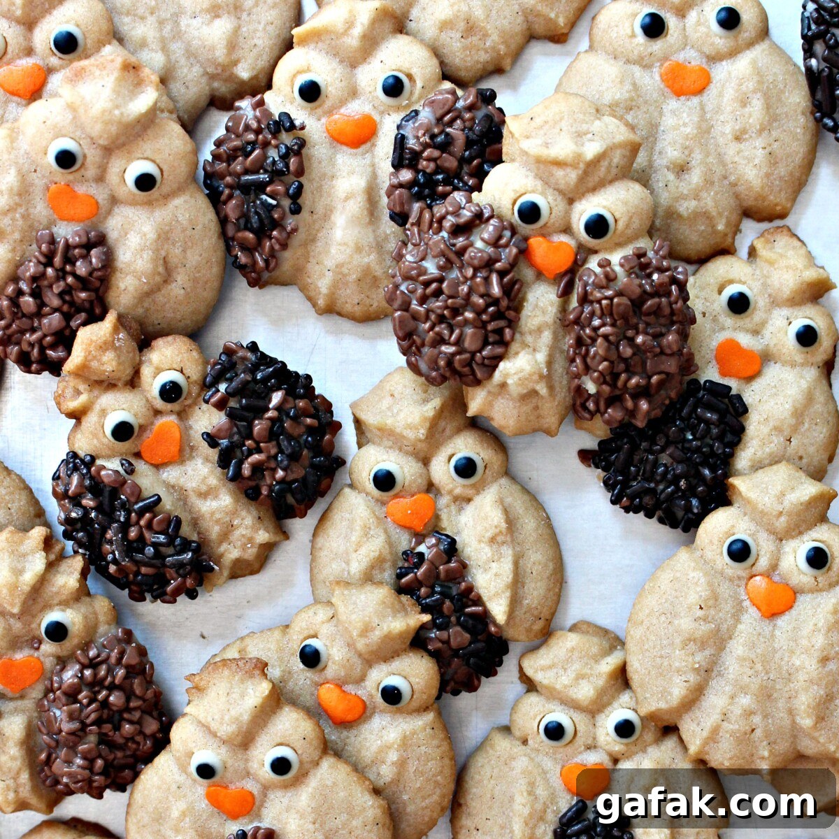 Cinnamon Spritz Owl Cookies are buttery cookies warmed with cinnamon and baked until crisp. A cookie press easily makes dozens of owls in minutes! | themondaybox.com Closeup of sprinkle decorated Cinnamon Spritz Owl Cookies.