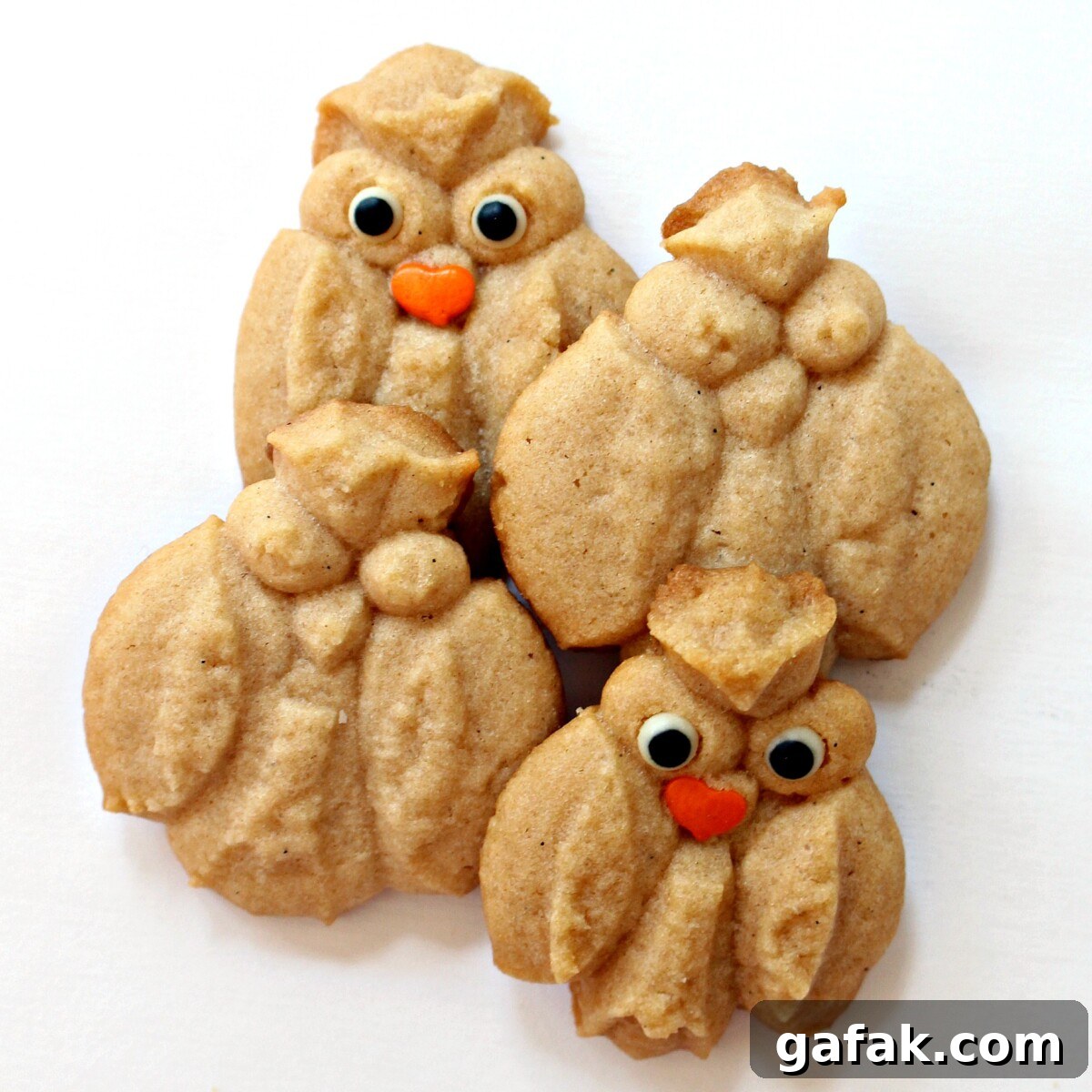 Cinnamon Spritz Owl Cookies are buttery cookies warmed with cinnamon and baked until crisp. A cookie press easily makes dozens of owls in minutes! | themondaybox.com Cinnamon Spritz Owl Cookies plain and with candy eyes and sprinkle beak.
