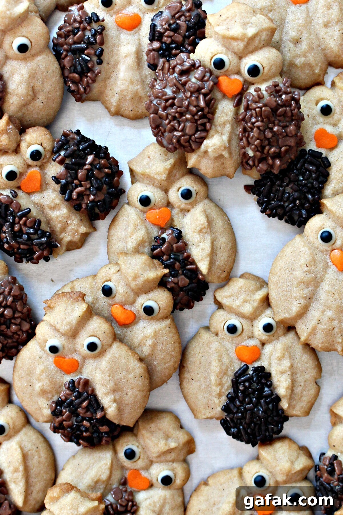 Cinnamon Spritz Owl Cookies are buttery cookies warmed with cinnamon and baked until crisp. A cookie press easily makes dozens of owls in minutes! | themondaybox.com Closeup of decorated Spritz Owl Cookies.