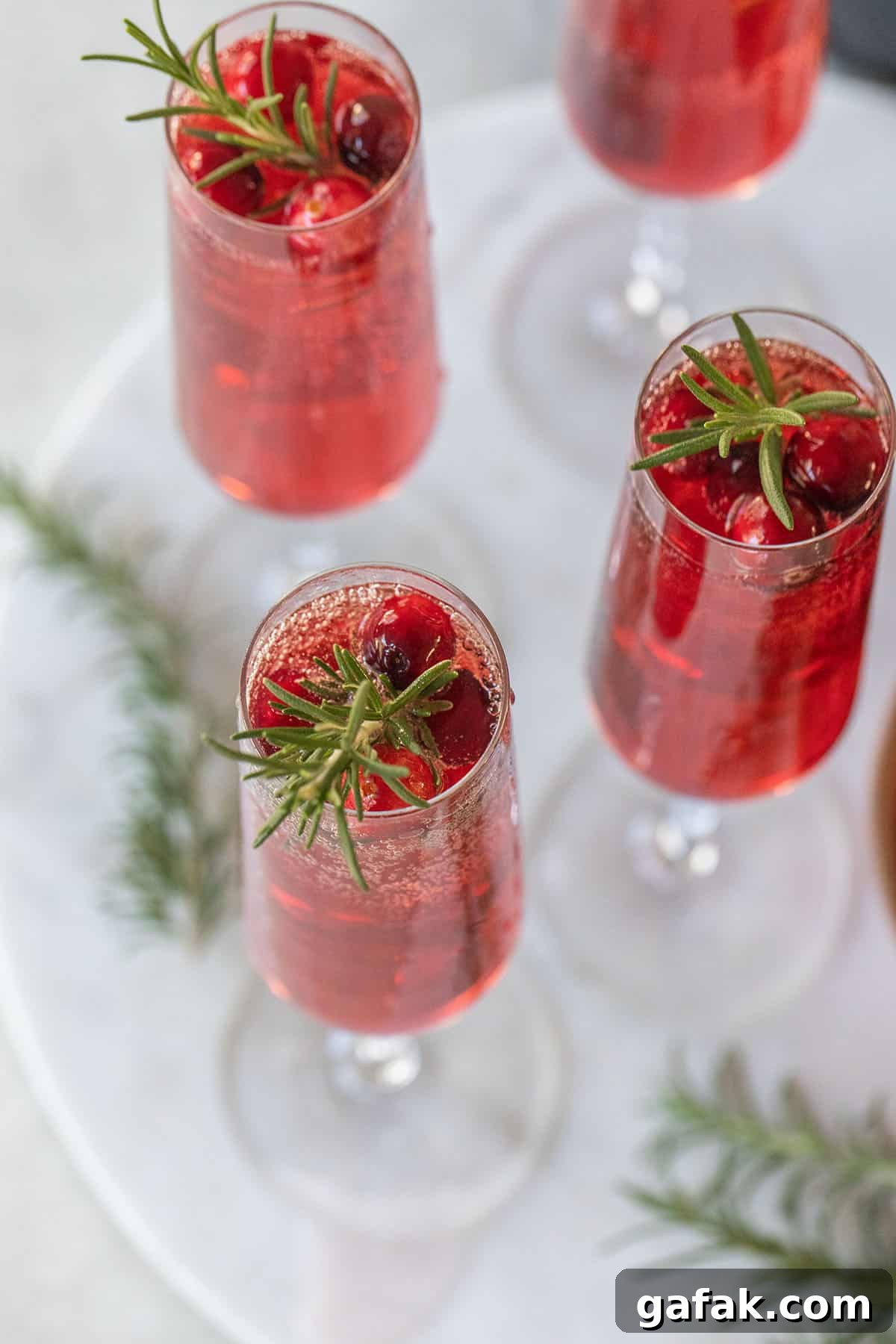 Champagne cranberry cocktail - a few fresh cranberries, 100 cranberry juice, plain champagne, cranberry mimosa.