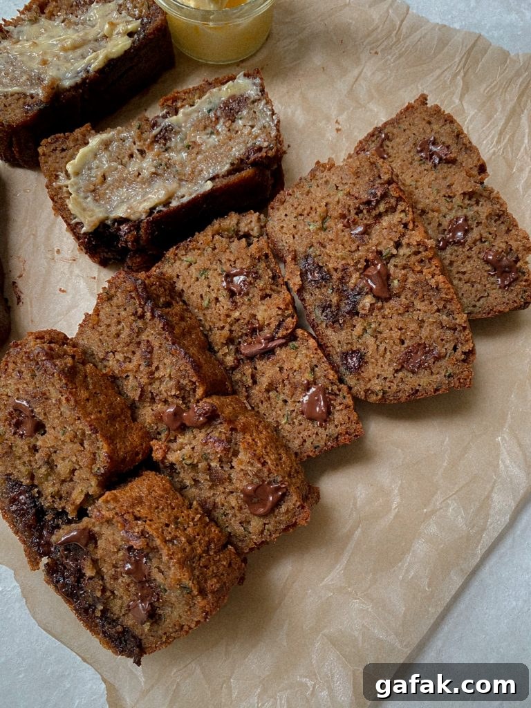 Gluten-Free Dairy-Free Zucchini Bread Recipe 2 sliced zucchini bread on parchment paper