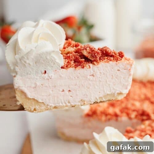 A slice of strawberry cheesecake being lifted with a cake server.