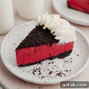 A slice of red velvet oreo cheesecake on a small white plate.
