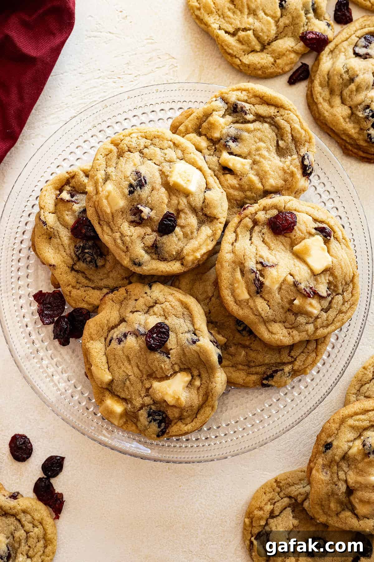 Overhead view of cookies on a plate. Cookies and red napkin in the corners.