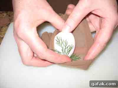 Tucking Easter Egg and leaf into pantyhose.
