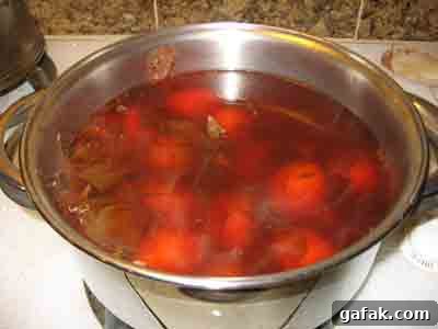 Easter eggs boiling in natural onion skin dye.