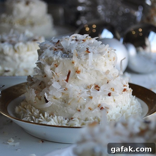 A mini Coconut Layer Cake frosted with Maple Italian Meringue Buttercream.