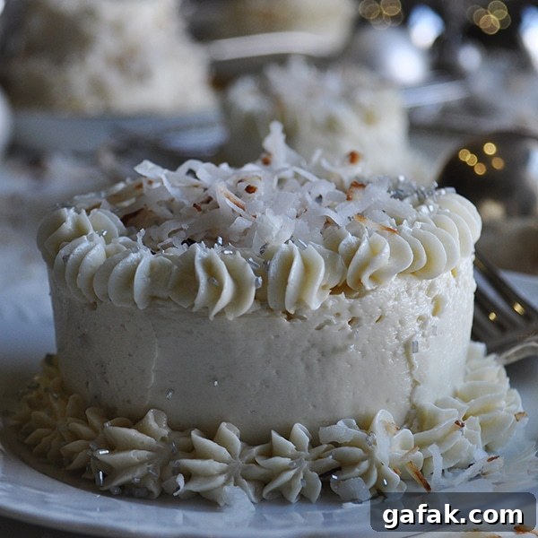 A mini Coconut Layer Cake frosted with Maple Italian Meringue Buttercream.