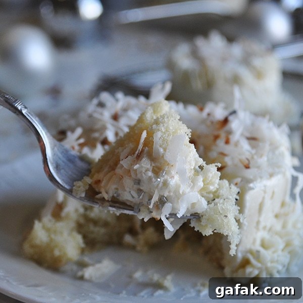 Taking a bite of a mini Coconut Cake with Maple Italian Meringue Buttercream