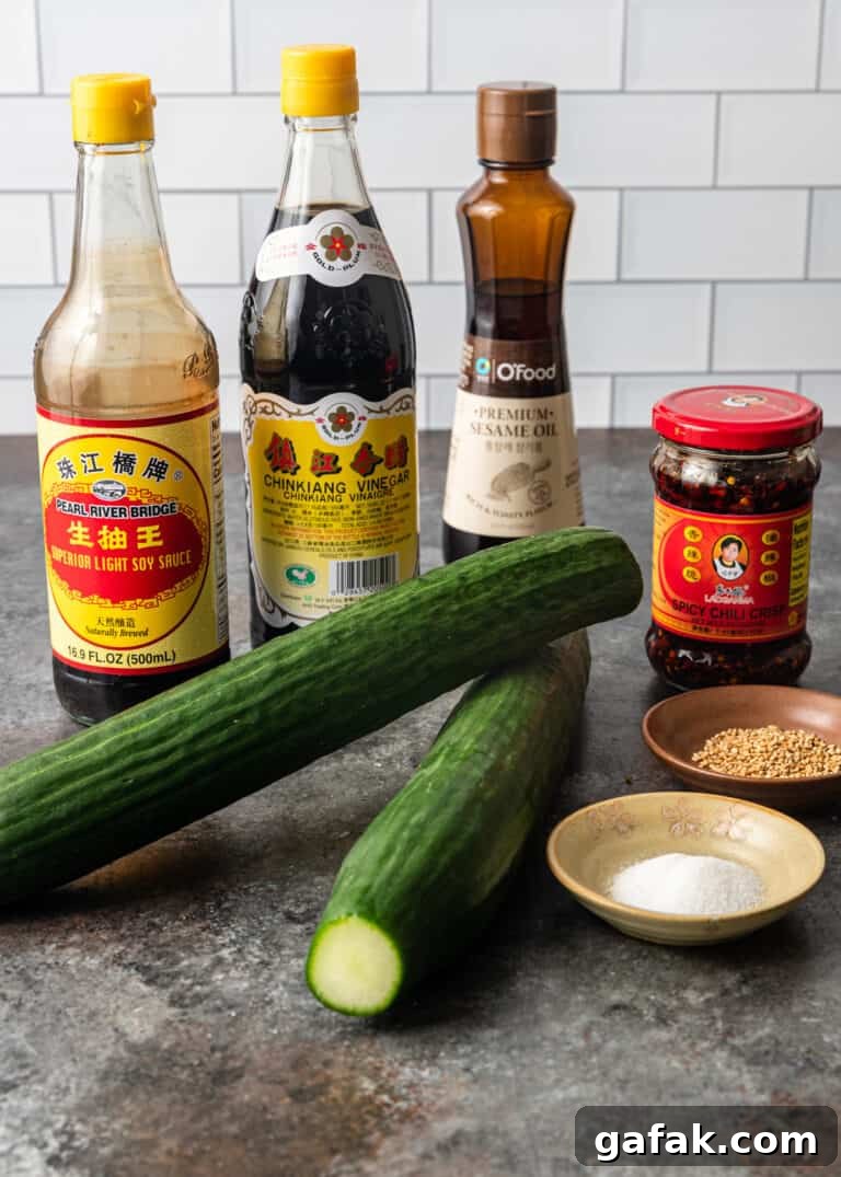 soy sauce, sesame oil,, long cucumbers and other ingredients needed to make huang gua salad