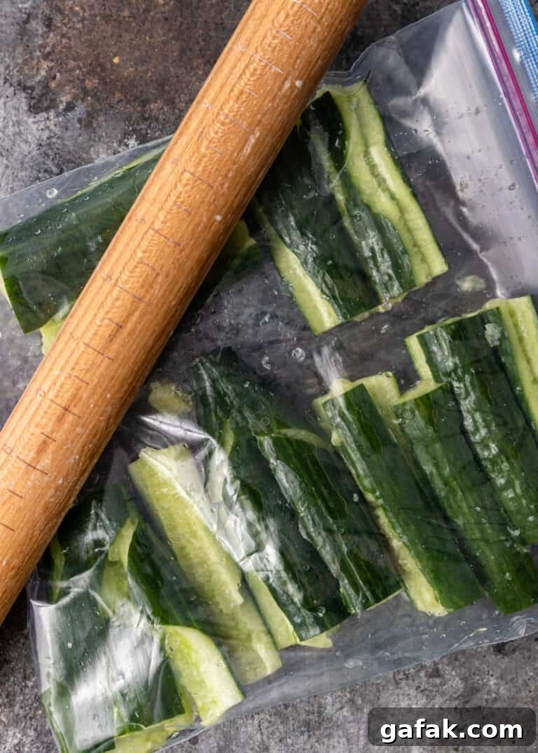 overhead: mashing cucumbers with a rolling pin for pai huang gua