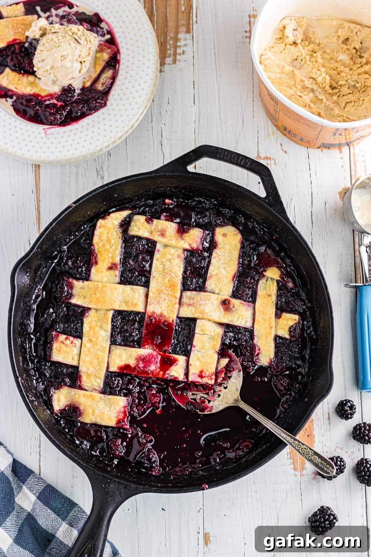 Blackberry cobbler with pie crust in a cast iron skillet.