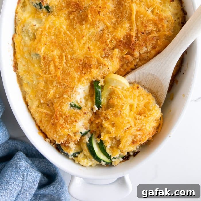 Cheesy Zucchini Casserole with Garlic and Herbs 9 Creamy baked zucchini casserole in a white casserole dish and filled with rows of sliced zucchini and yellow squash and topped with a golden crust of panko breadcrumbs, and shredded cheese.