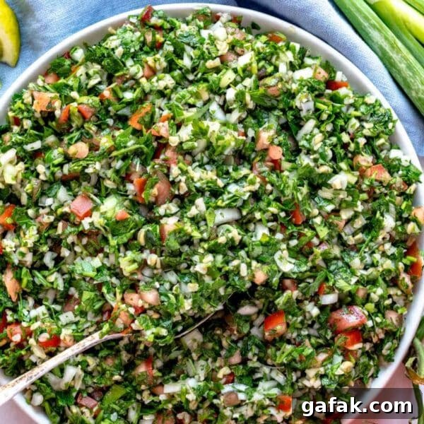 Fatteh with Pita, Hummus, and Creamy Yogurt Bowl 19 Healthy tabouli (tabbouleh) recipe served as a Mediterranean salad with pita bread and fresh herbs, perfect for plant-based eating.