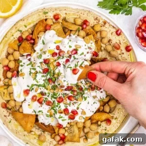 Fatteh with Pita, Hummus, and Creamy Yogurt Bowl 20 Fatteh hummus with hand and red nails
