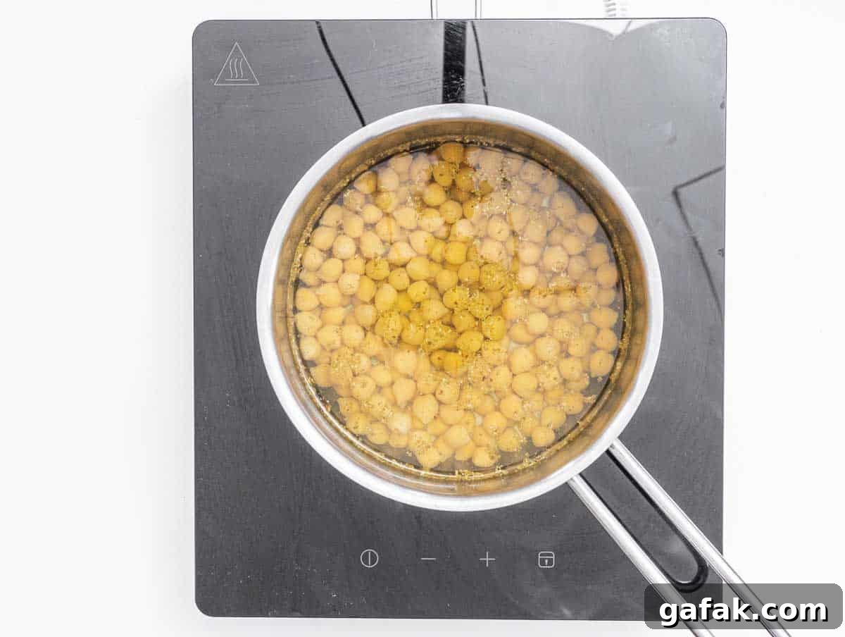 Fatteh with Pita, Hummus, and Creamy Yogurt Bowl 6 boiling chickpeas in a pot