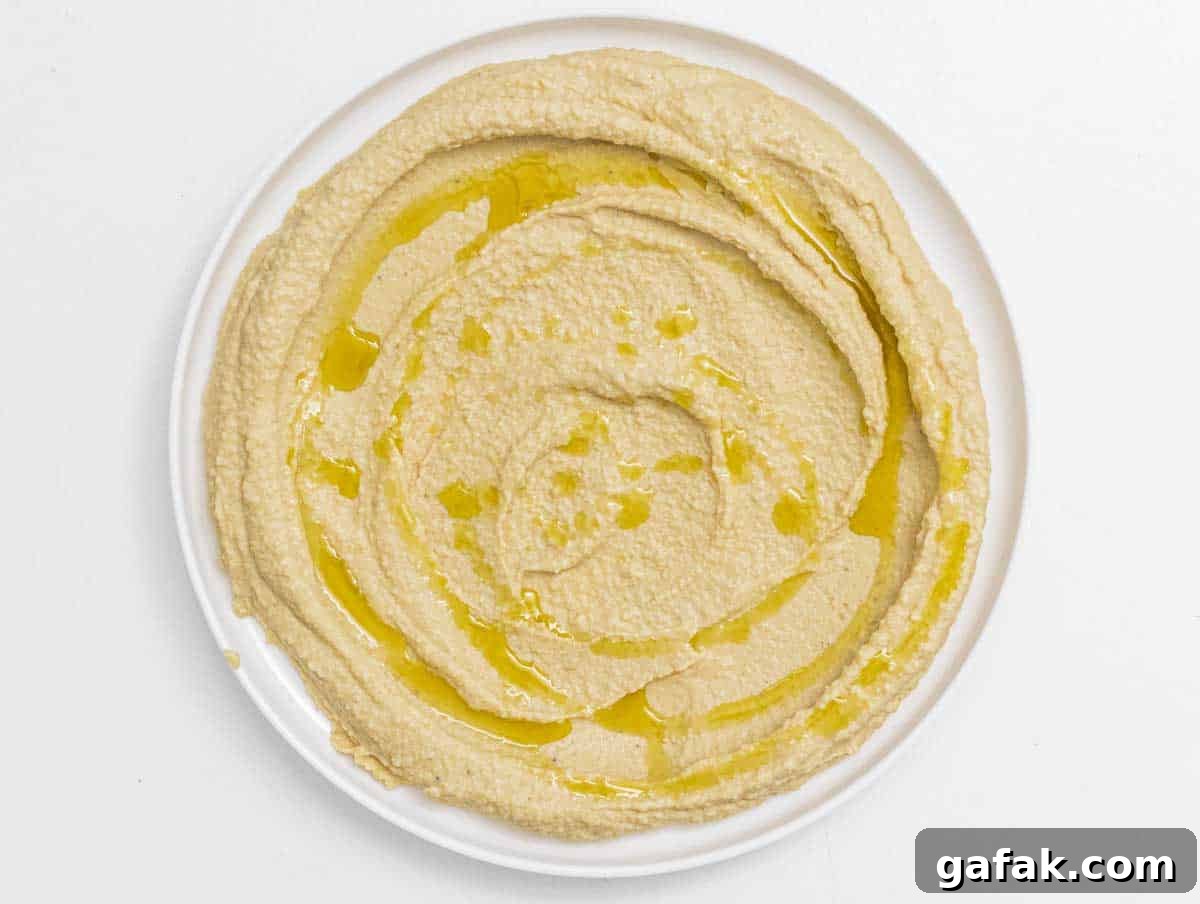 Fatteh with Pita, Hummus, and Creamy Yogurt Bowl 9 hummus on a plate