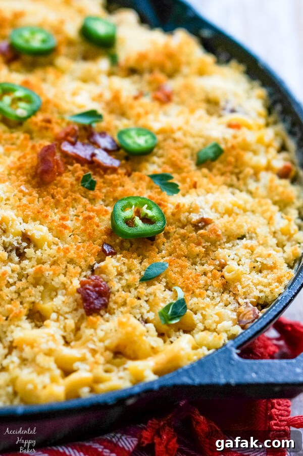 A close up showing the browned bread crumbs, bacon and jalapenos topping the macaroni and cheese.