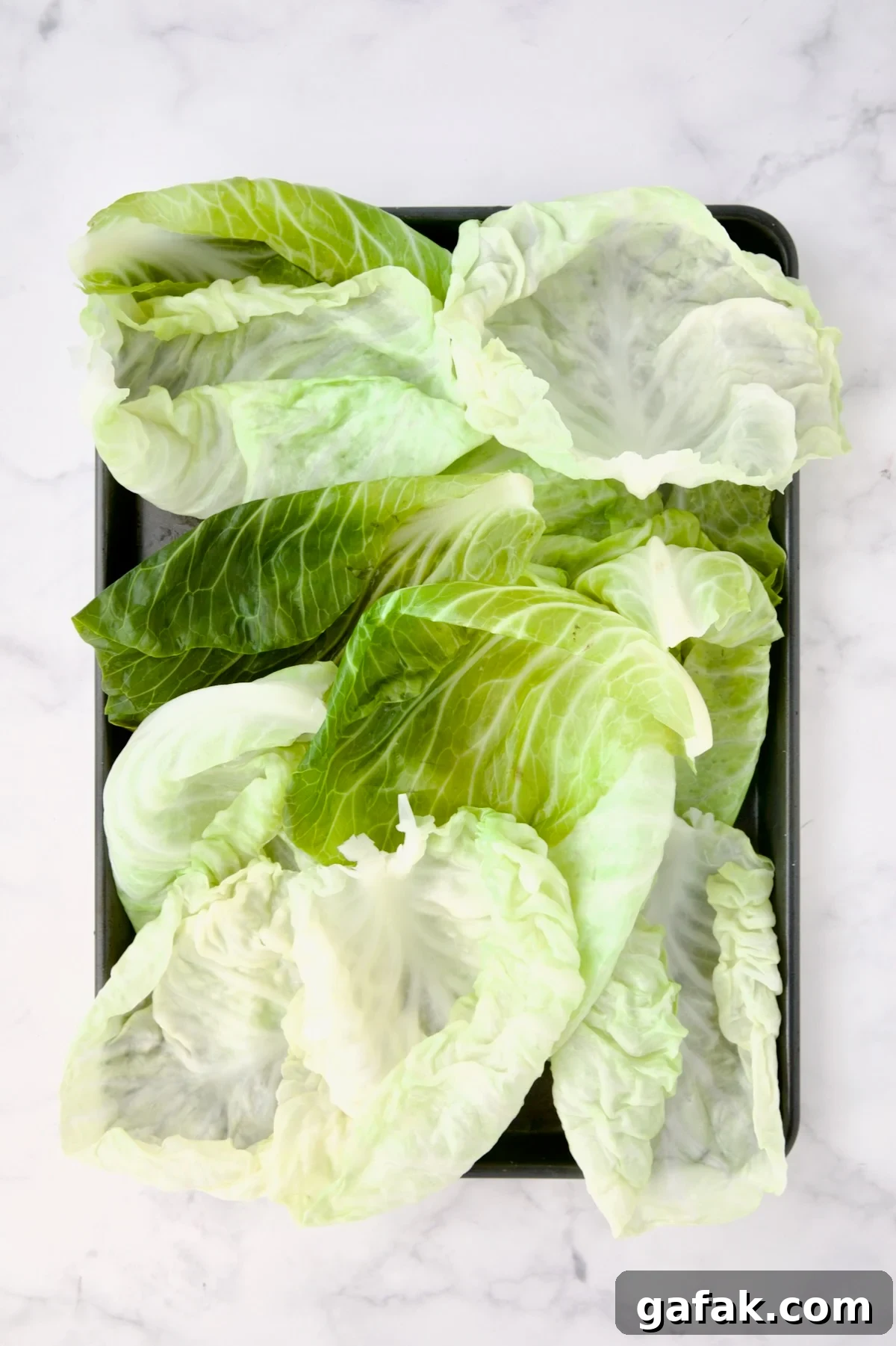 12 lettuce leaves on rimmed baking sheet.